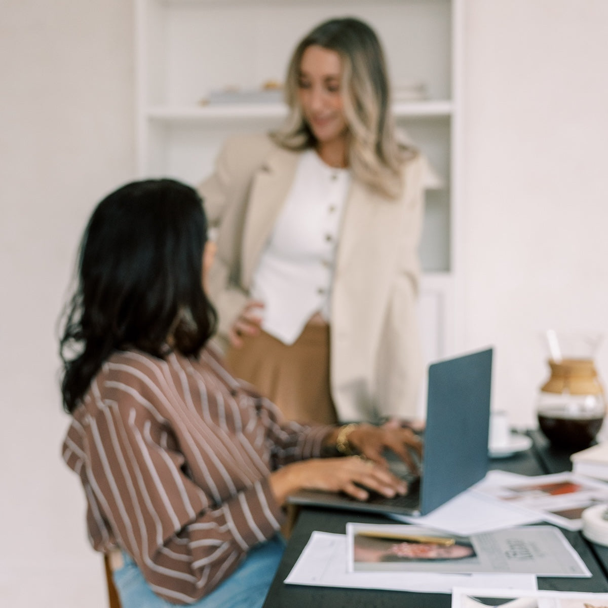 Service provider reviewing a Dubsado contract on a laptop with two client signature fields visible