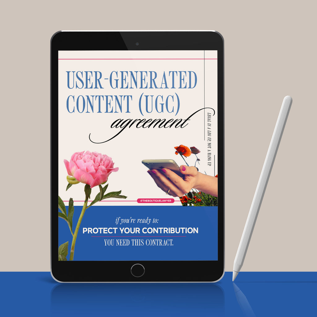 Digital tablet displaying a "User-Generated Content agreement" with poppies and a hand holding a phone, stylus beside it.