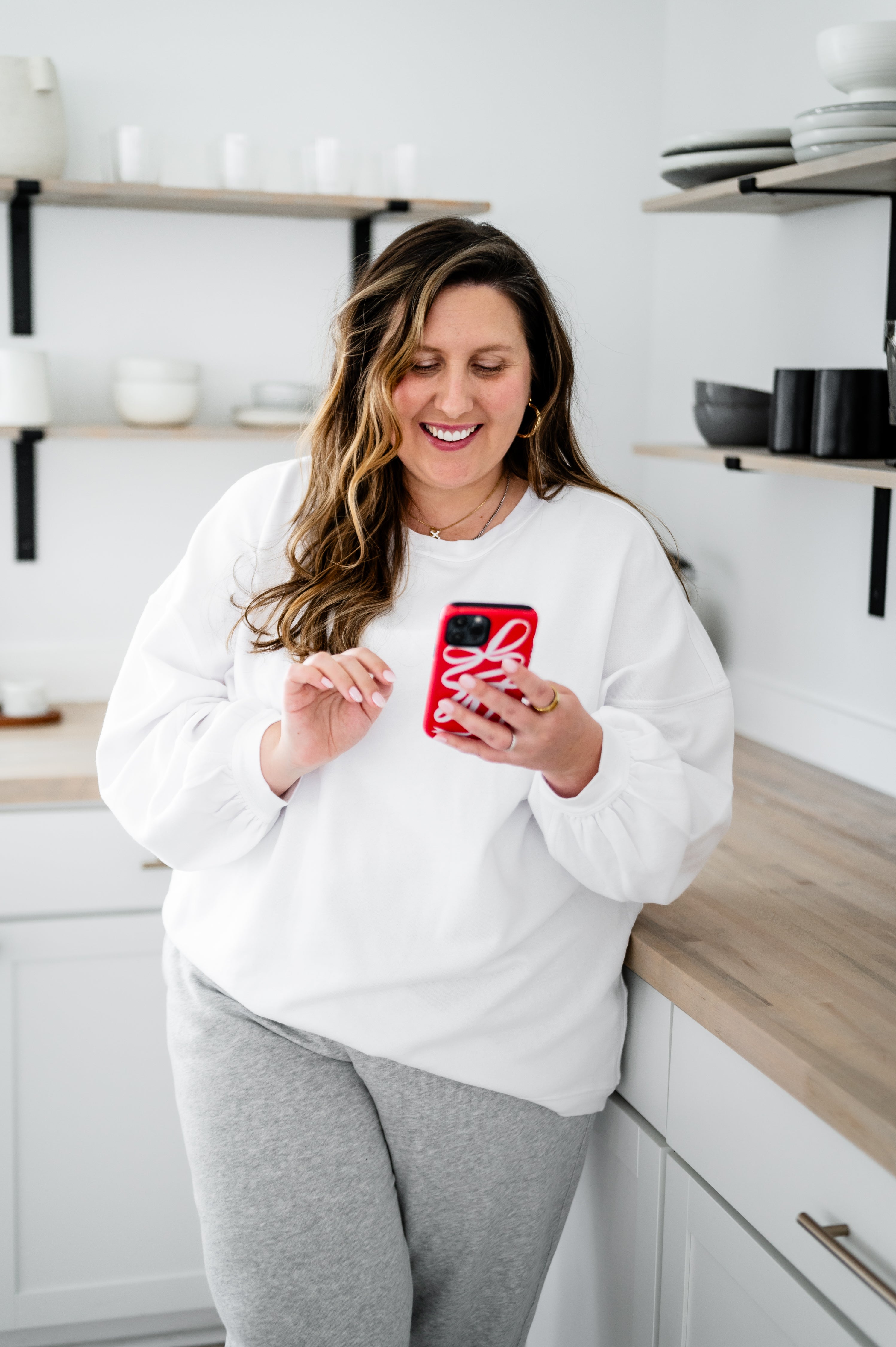 Attorney and founder, Amber, holding her phone and working with creative entrepreneurs and service providers to protect their businesses.