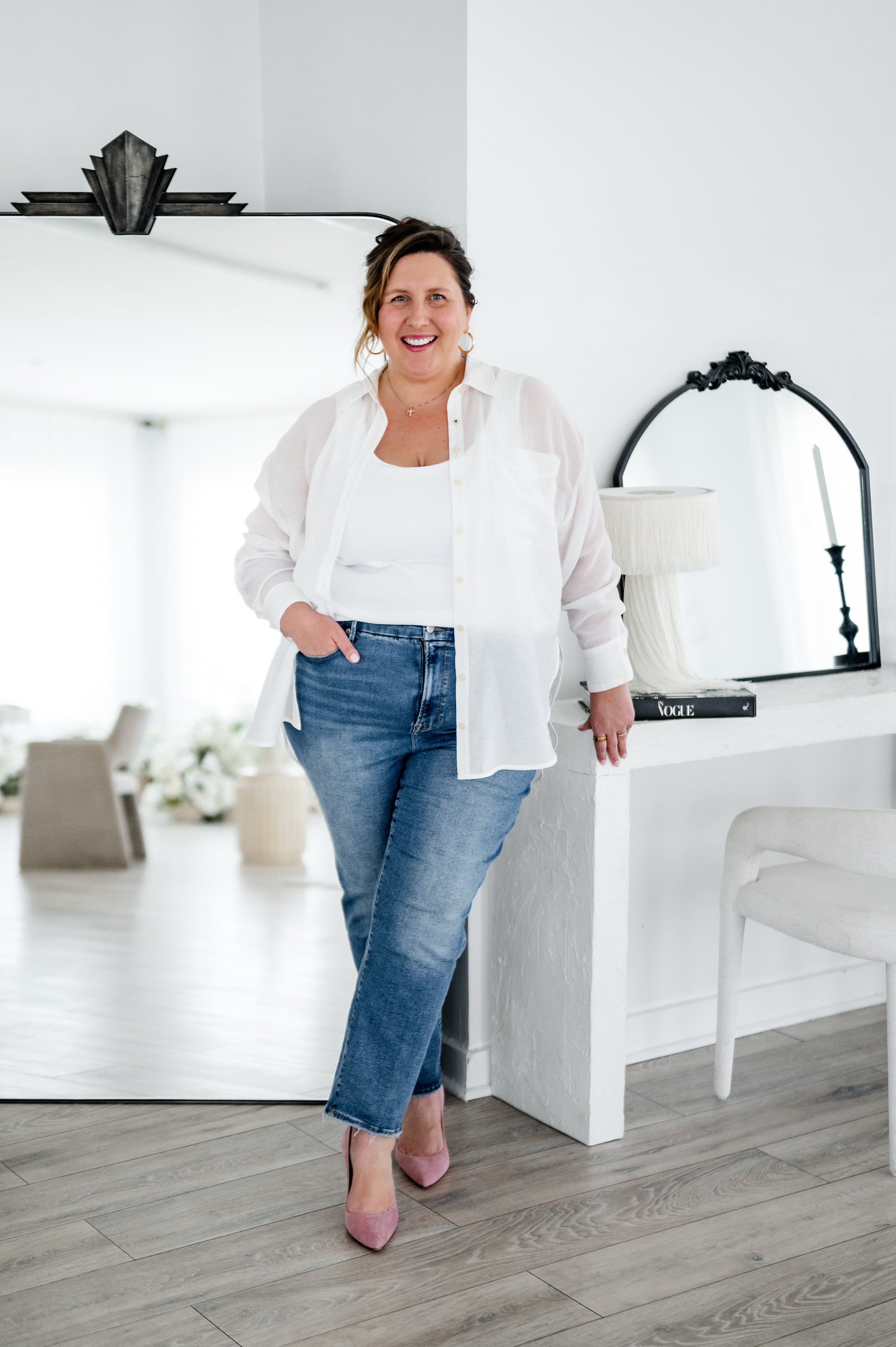 The Boutique Lawyer, a boutique attorney providing contract templates for creatives and service providers standing in a room by her desk.