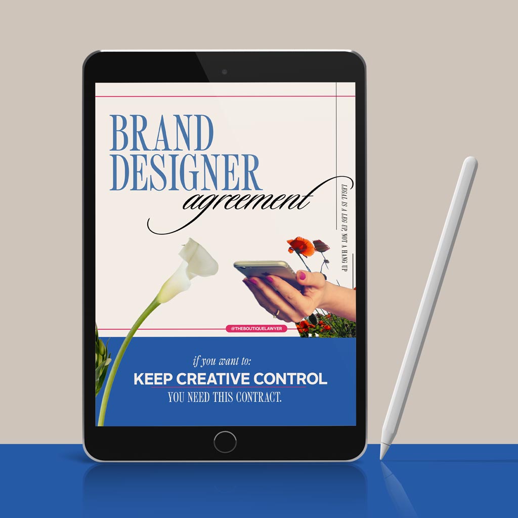 Digital tablet displaying a "Brand Designer agreement" with flower and a hand holding a phone, stylus beside it.